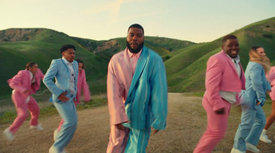 a group of men in pink and blue outfits