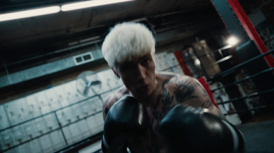 a man with white hair wearing boxing gloves