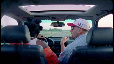 a man driving a car with a woman in the passenger seat