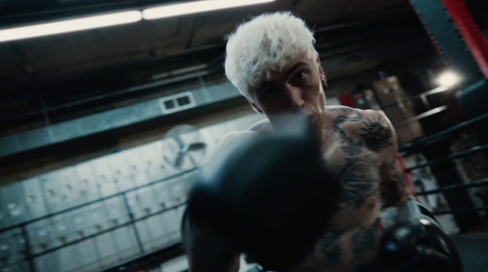 a man with white hair wearing boxing gloves