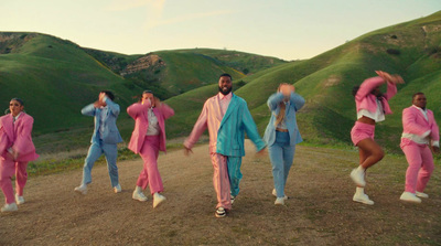 a group of people dressed in pink and blue dancing