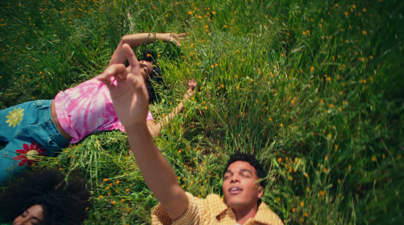 a man and a little girl laying in the grass