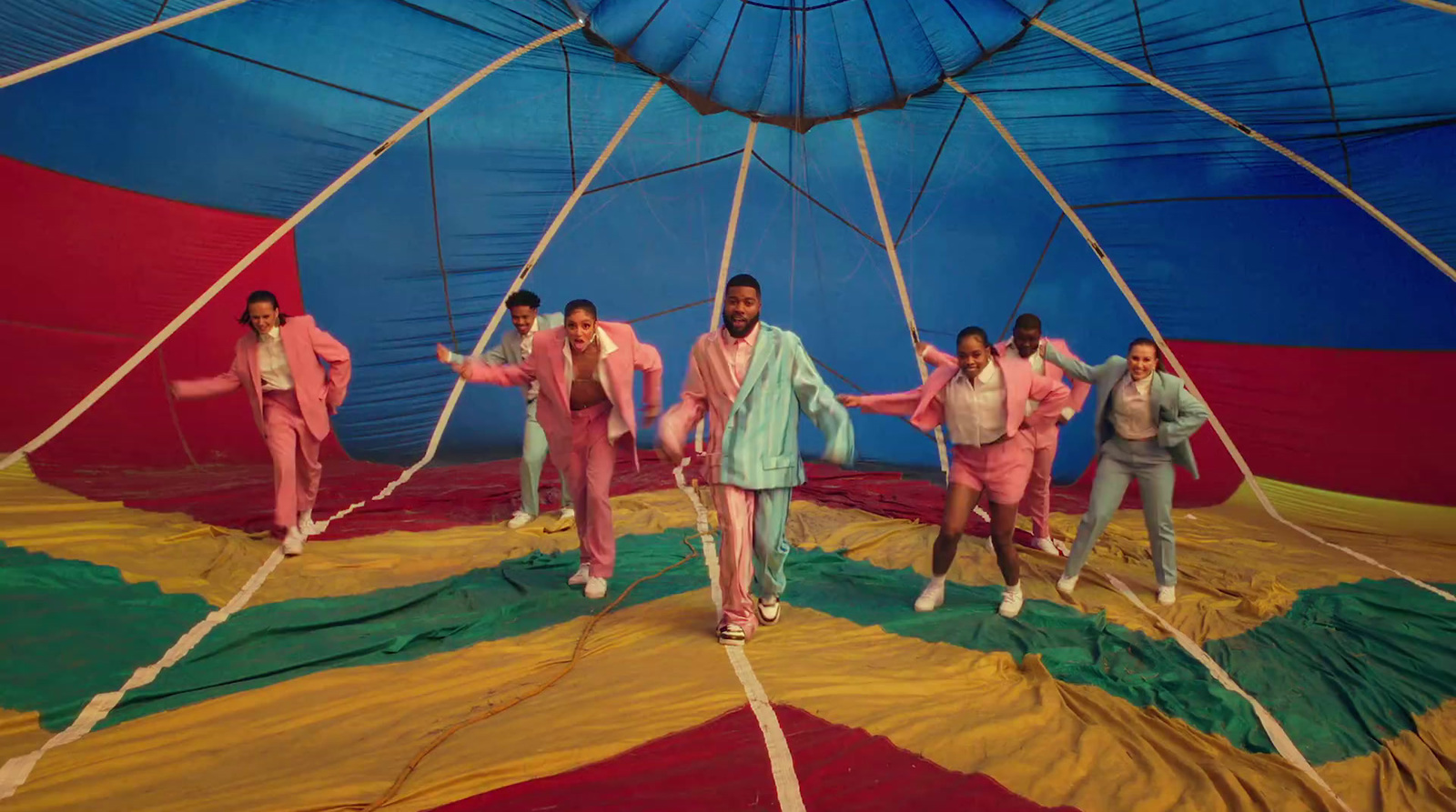 a group of people standing on top of a parachute