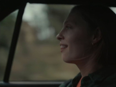 a woman sitting in the passenger seat of a car