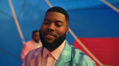 a close up of a person wearing a suit and tie