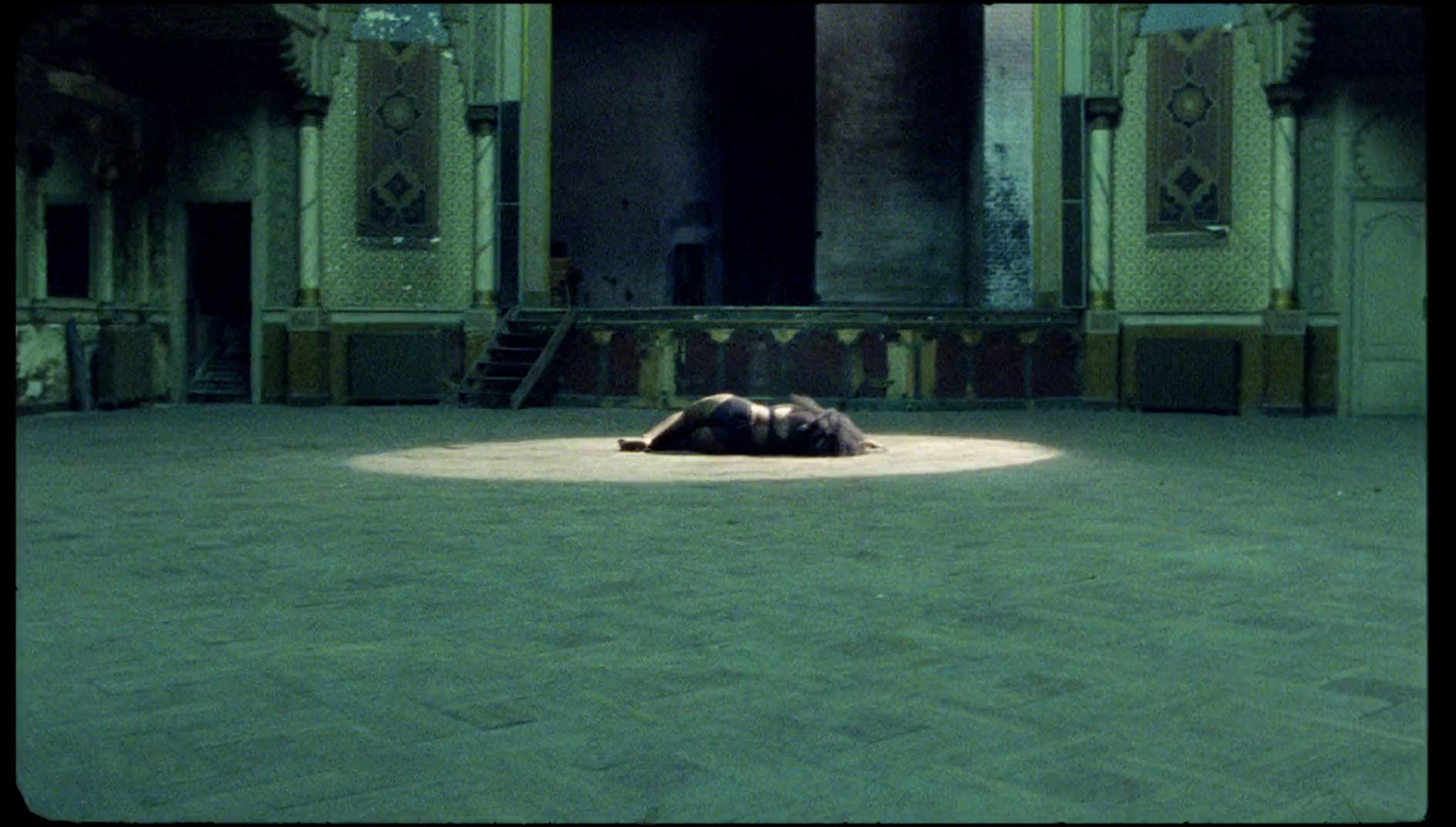 a person laying on the ground in a large room