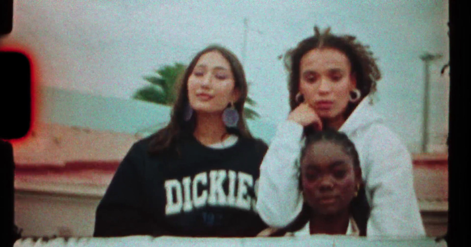 three girls are posing for a picture together