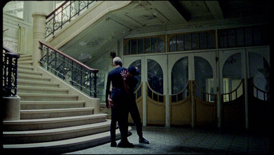 a couple of people standing in front of some stairs