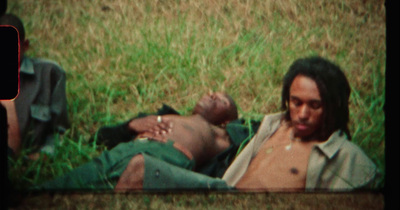 a man laying on the ground next to another man