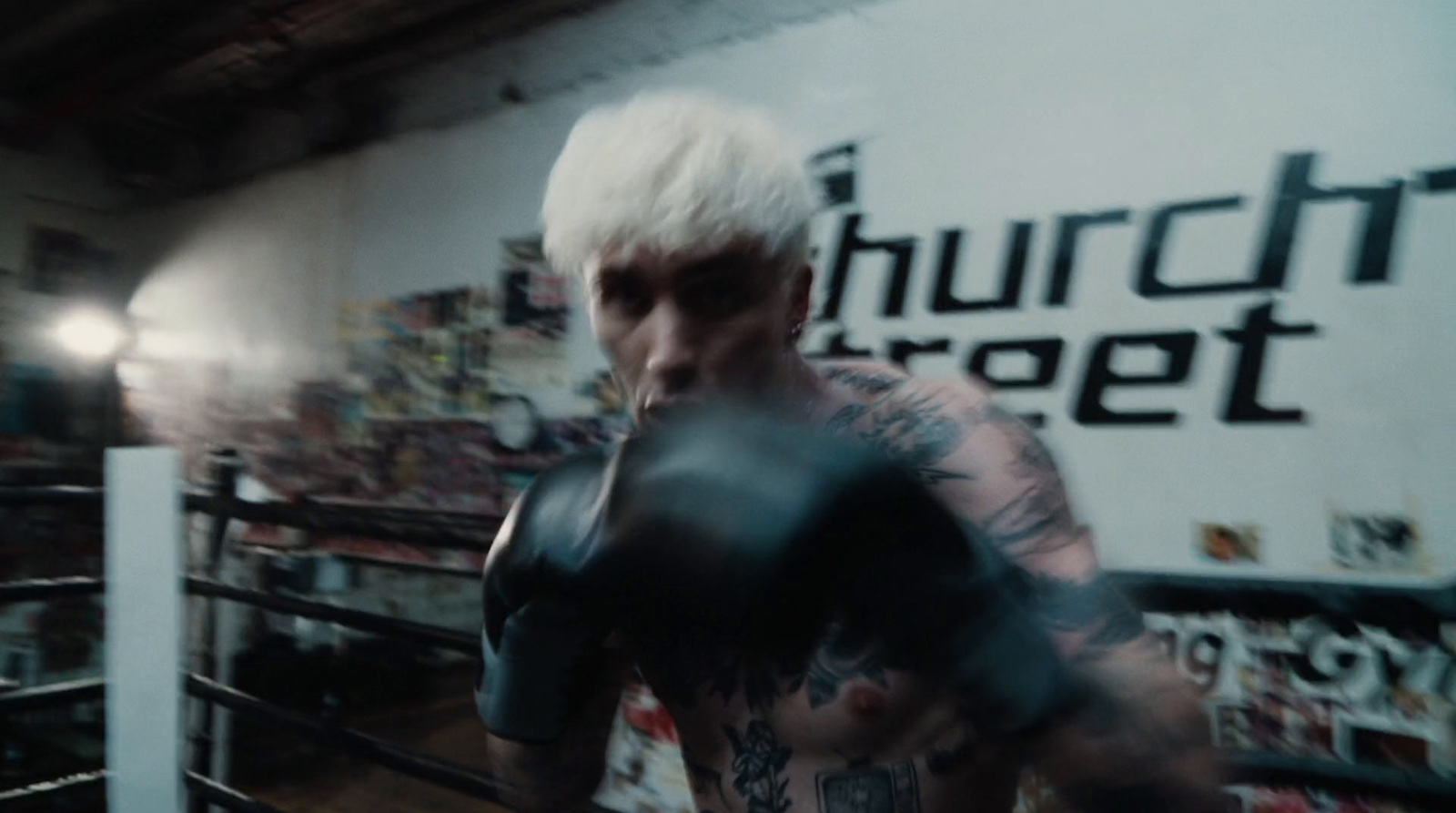 a man with white hair wearing boxing gloves