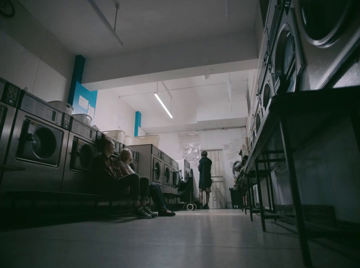 a couple of people sitting on a bench in a room