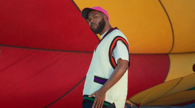 a man standing in front of a colorful wall