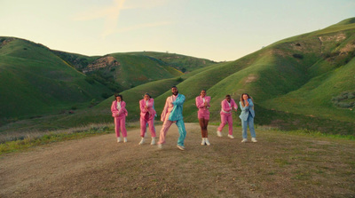 a group of people standing on top of a dirt field