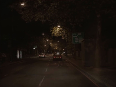 a dark city street at night with street lights