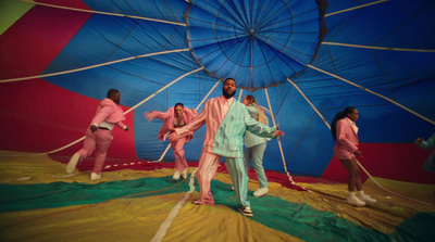 a group of people standing on top of a parachute