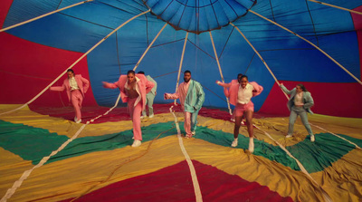 a group of men standing on top of a parachute