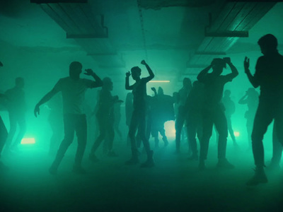 a group of people dancing in a dark room