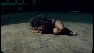 a woman in a bathing suit laying on the floor