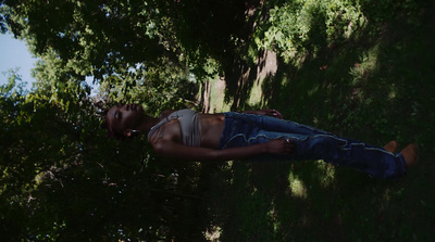 a man laying in the shade of a tree