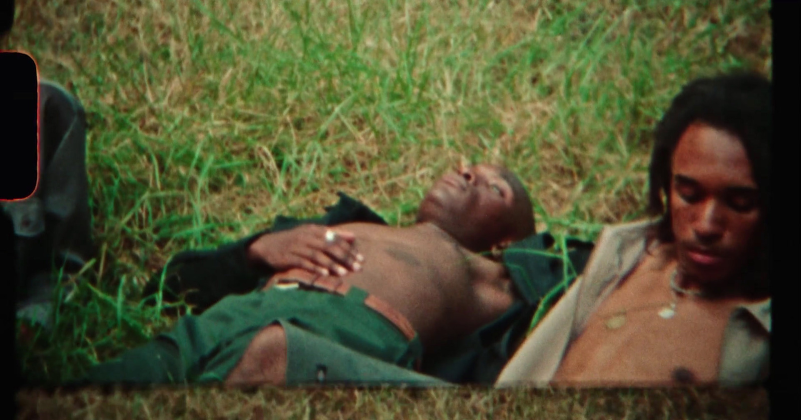 a man laying on the ground next to a woman