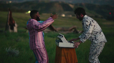 a couple of men standing next to each other in a field