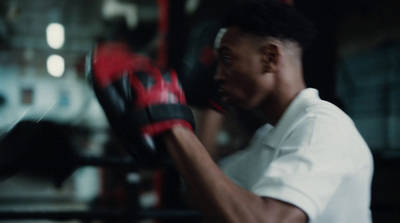 a man wearing boxing gloves in a gym