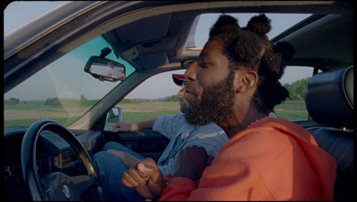 a man driving a car with a woman in the passenger seat