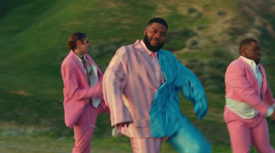 a man in a pink suit and three other men in pink suits