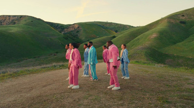 a group of people standing on a dirt road