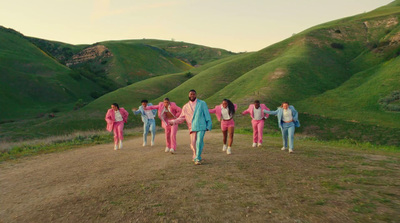 a group of people walking down a dirt road