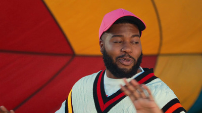 a man wearing a pink hat and a white shirt