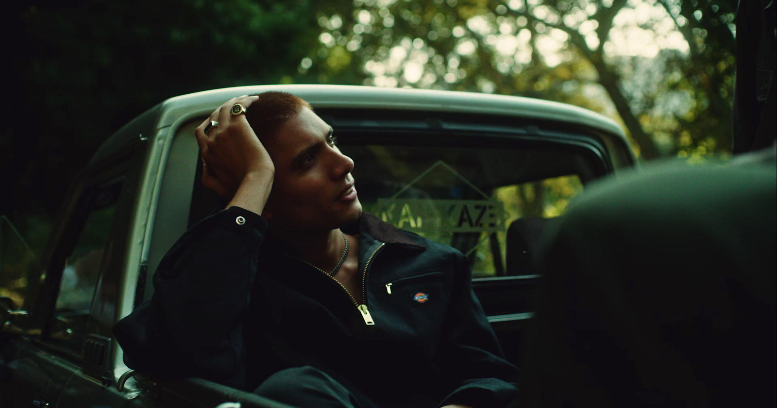 a man sitting in the back of a truck