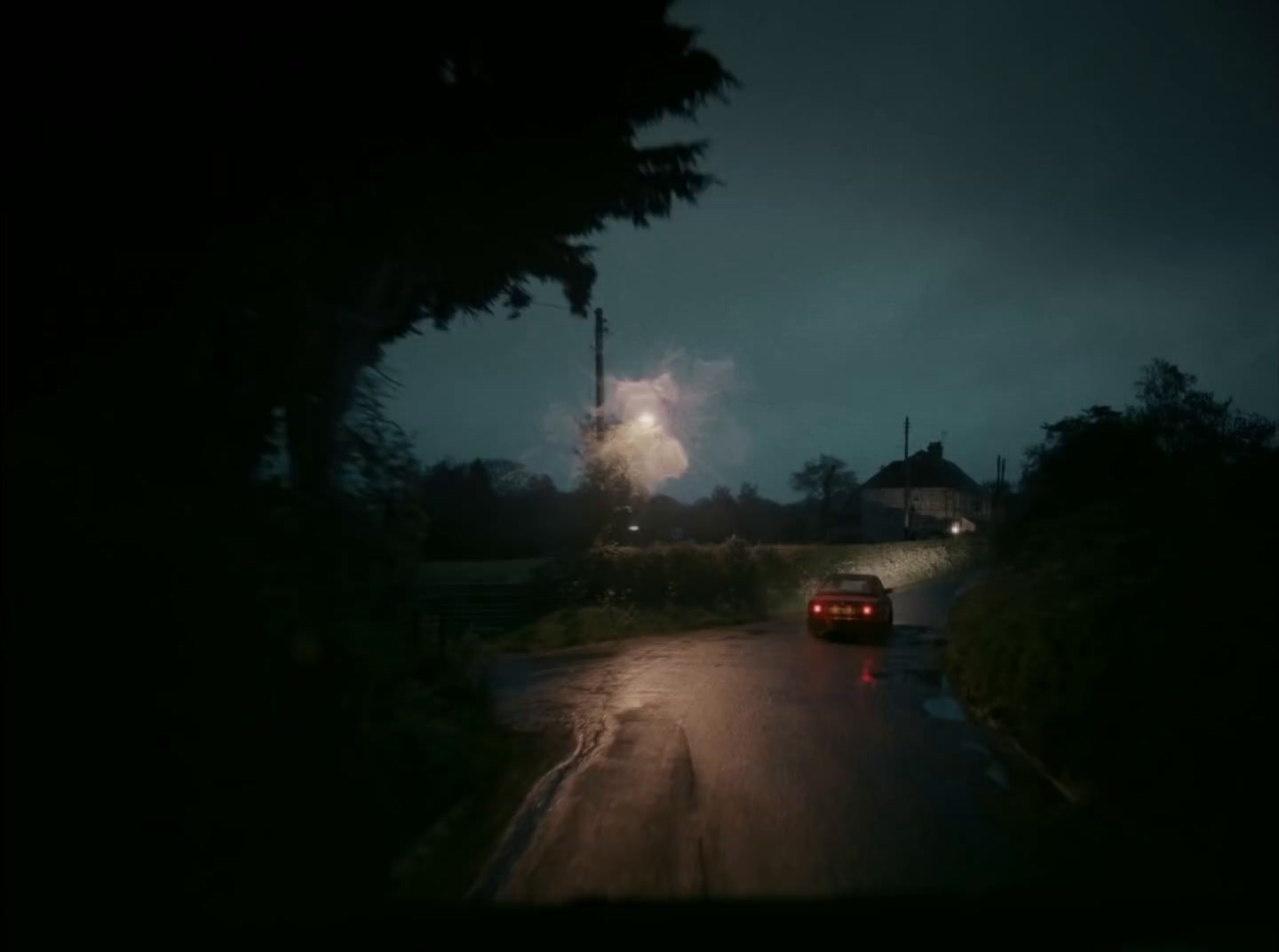 a car driving down a street at night