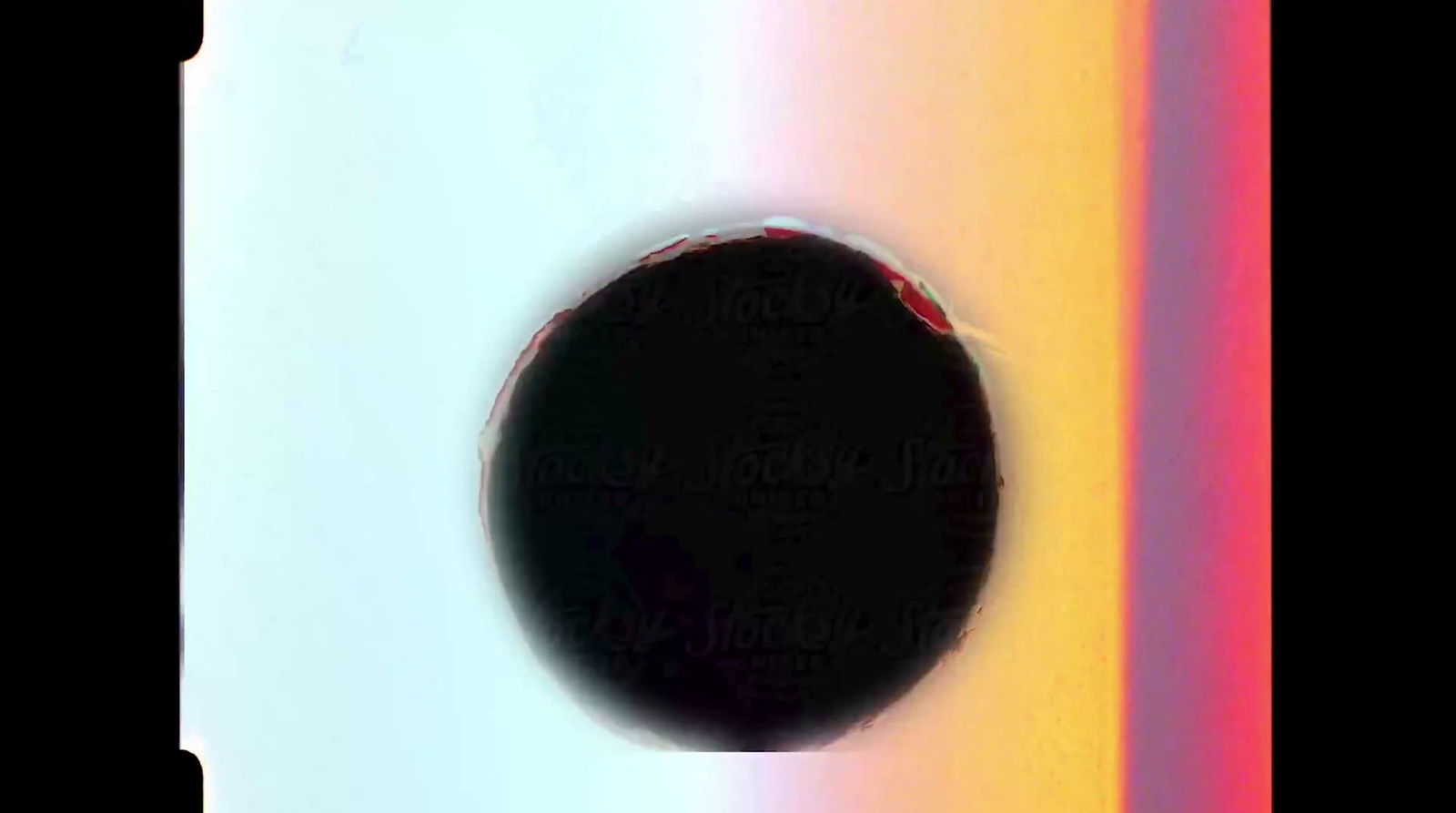 a round object with a black circle in the middle of it