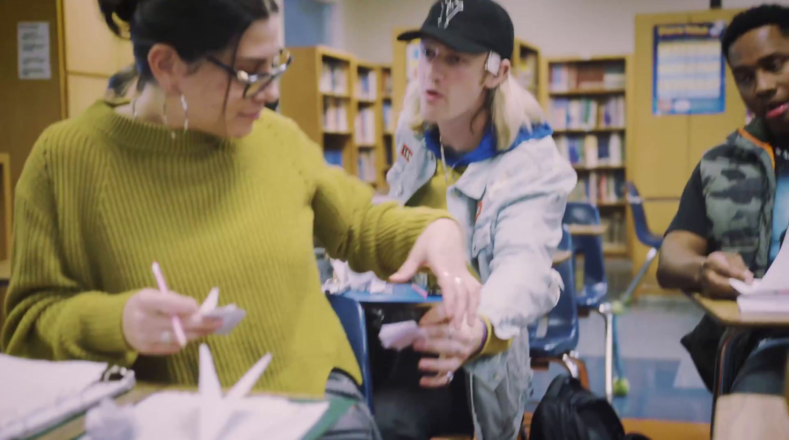 a group of people sitting around a table in a library