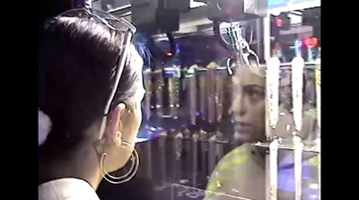 a woman wearing a pair of ear phones in front of a store window