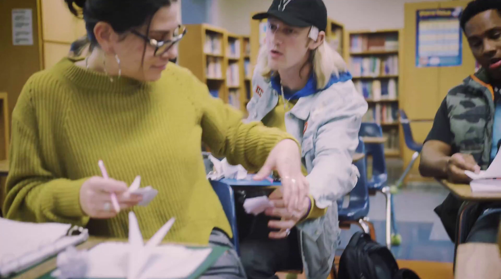 a group of people sitting around a table in a library