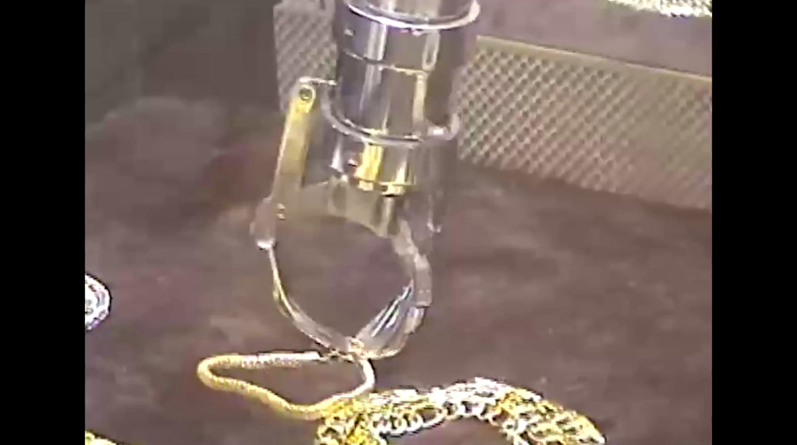 a yellow snake is on the ground next to a glass