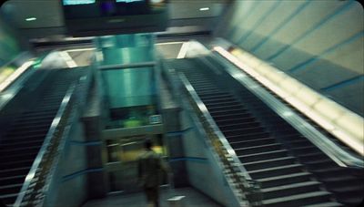 an escalator with a man walking down it