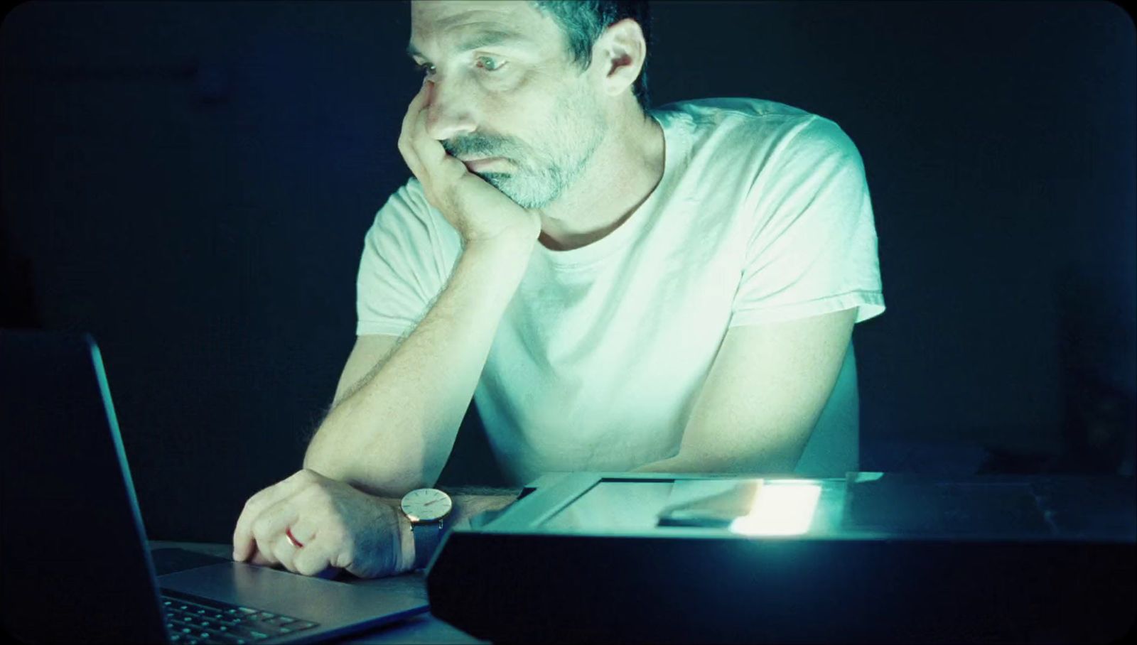 a man sitting in front of a laptop computer