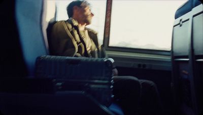 a man sitting on a bus looking out the window