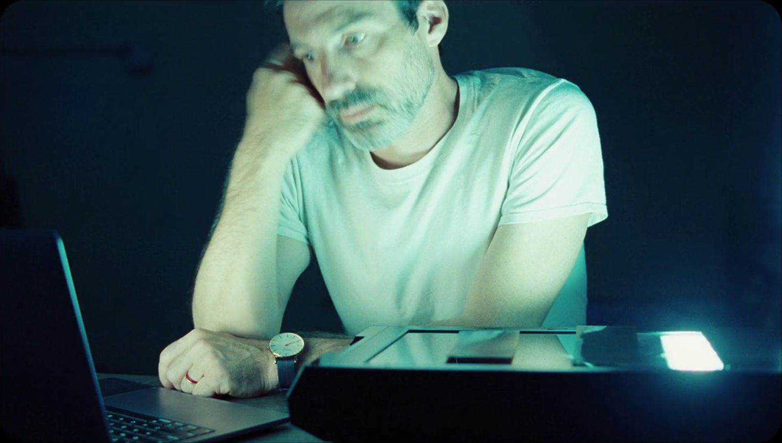 a man sitting in front of a laptop computer