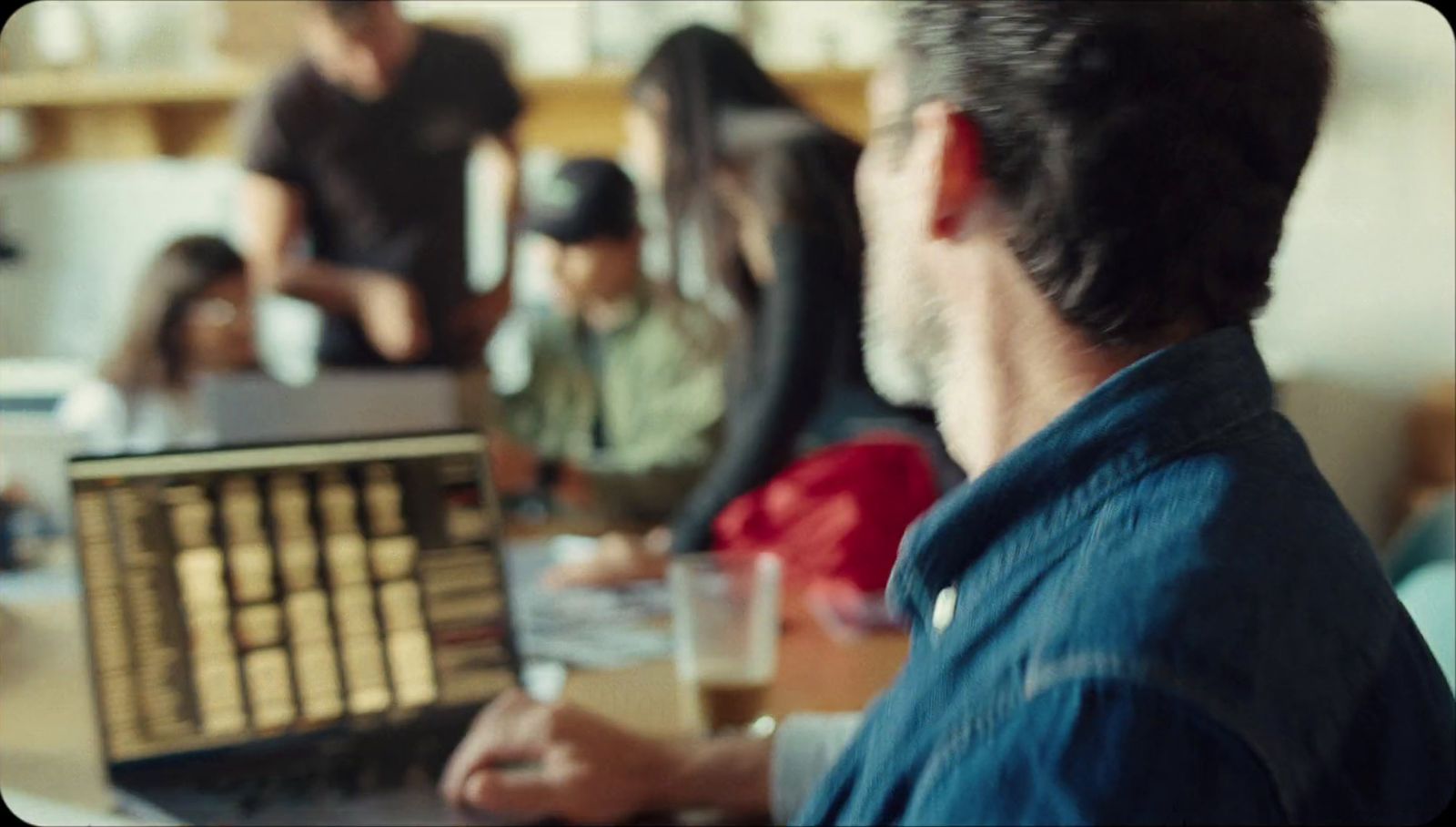 a man sitting in front of a laptop computer