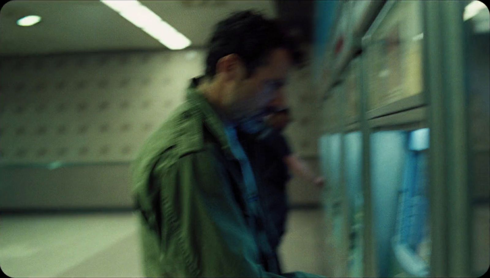 a man standing next to a refrigerator in a room