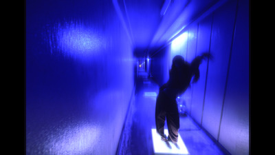 a person in a dark room with a blue light