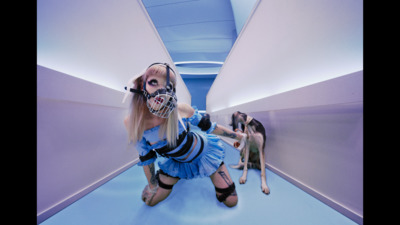 a woman in a costume and a dog in a hallway