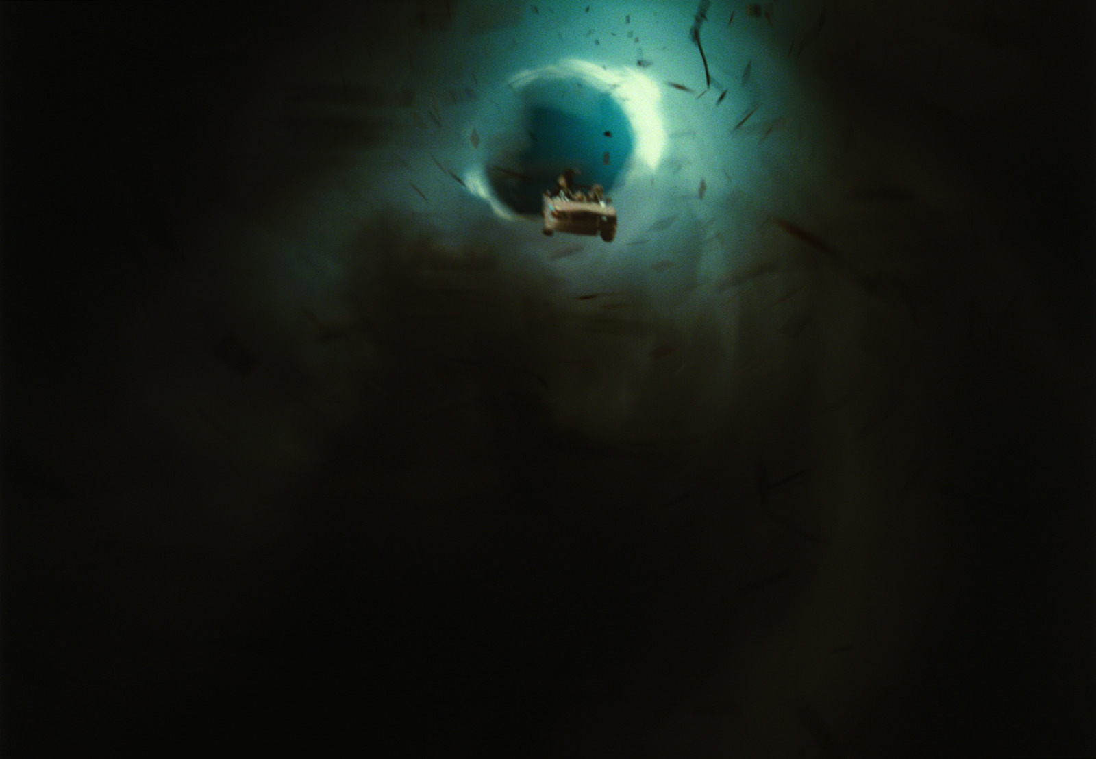 a small boat floating in a dark ocean