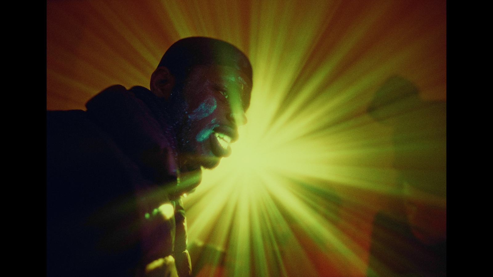 a man standing in front of a bright light