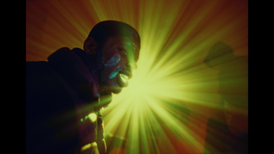 a man standing in front of a bright light