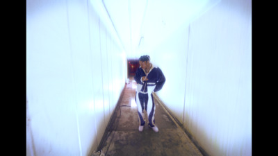 a woman is walking down a long hallway